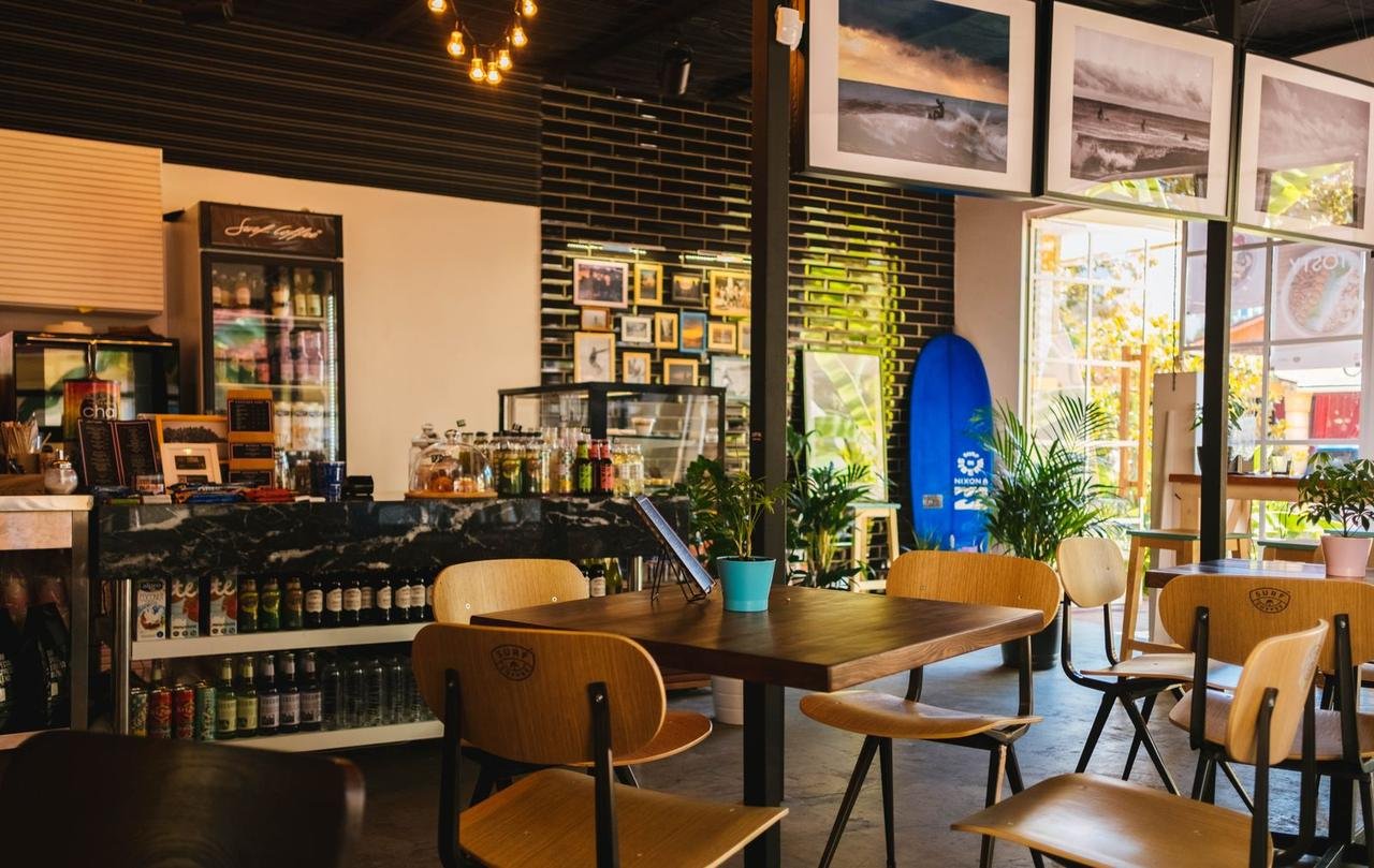 A café counter with coffee equipment and warm interior light